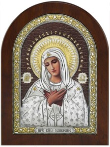 The icon of the Mother of God "Tenderness" is brown with colored decor