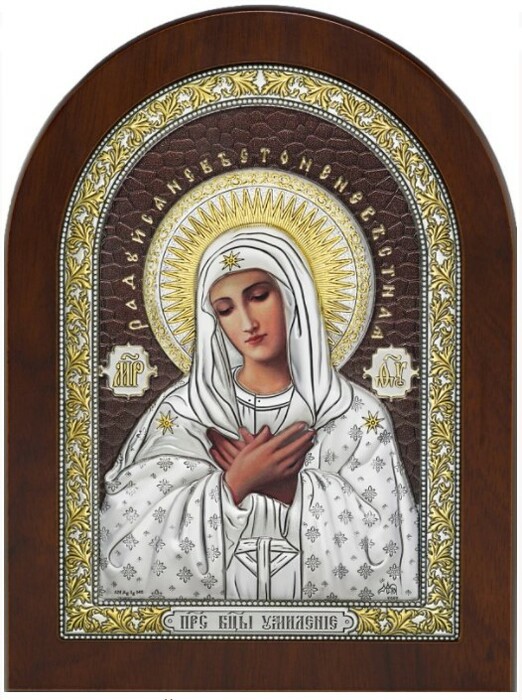 The icon of the Mother of God "Tenderness" is brown with colored decor