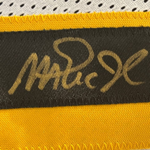 An autographed jersey of basketball player Magic Johnson