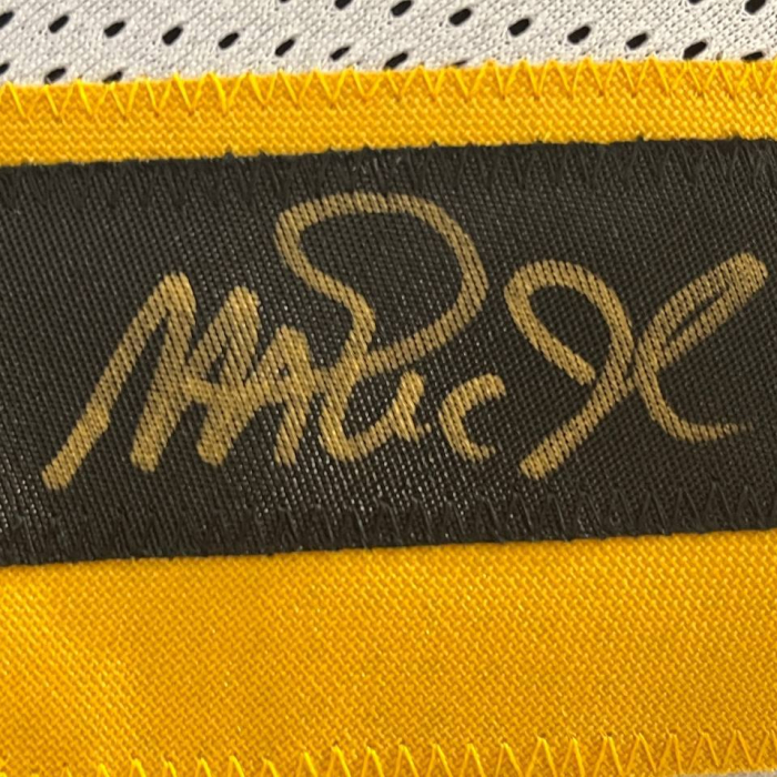 An autographed jersey of basketball player Magic Johnson